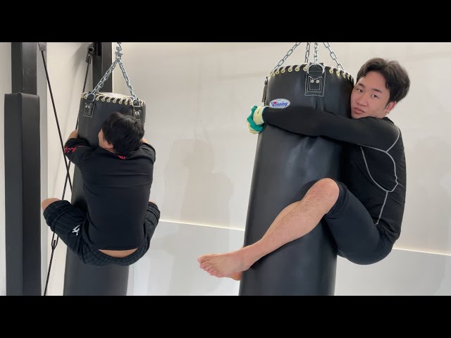 Endurance challenge by hanging from a punching bag, phone call to