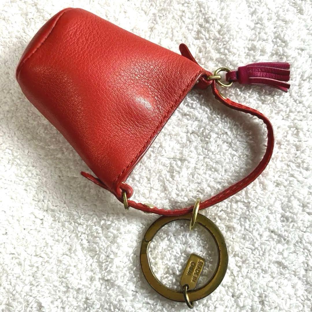 コーチ レザー レッド ミニ小物入れ タッセル付き キーチャーム 公式